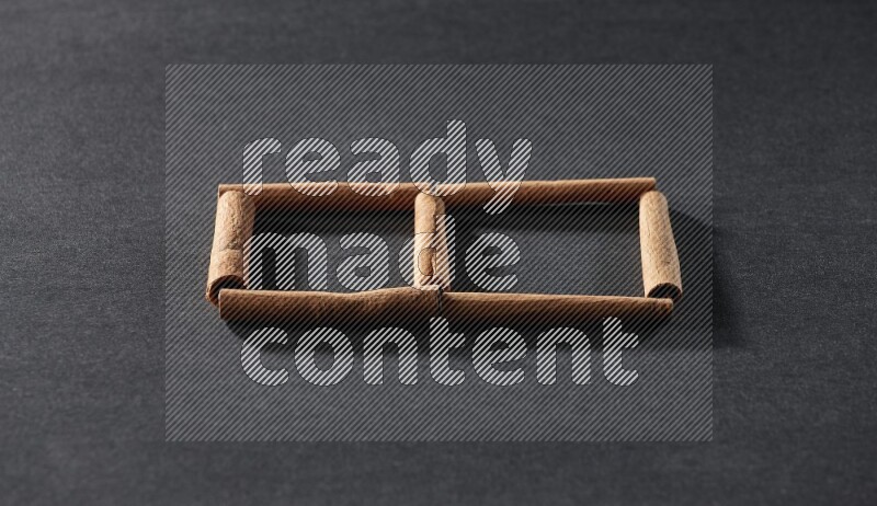 2 squares of cinnamon sticks on black flooring