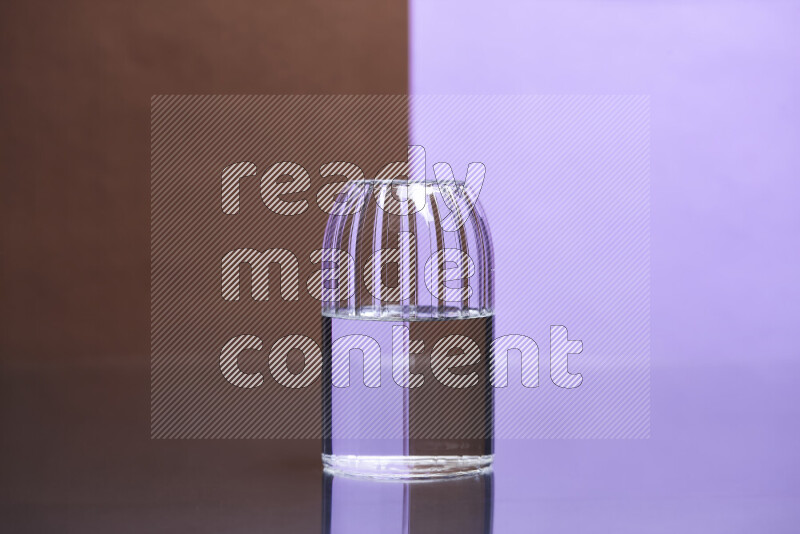 The image features a clear glassware filled with water, set against brown and light purple background