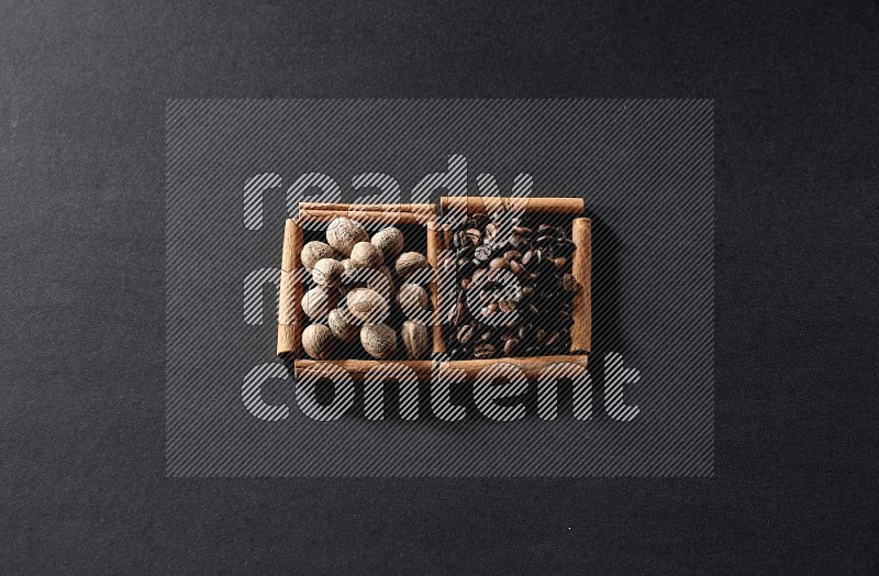 2 squares of cinnamon sticks full of coffee beans and nutmeg on black flooring
