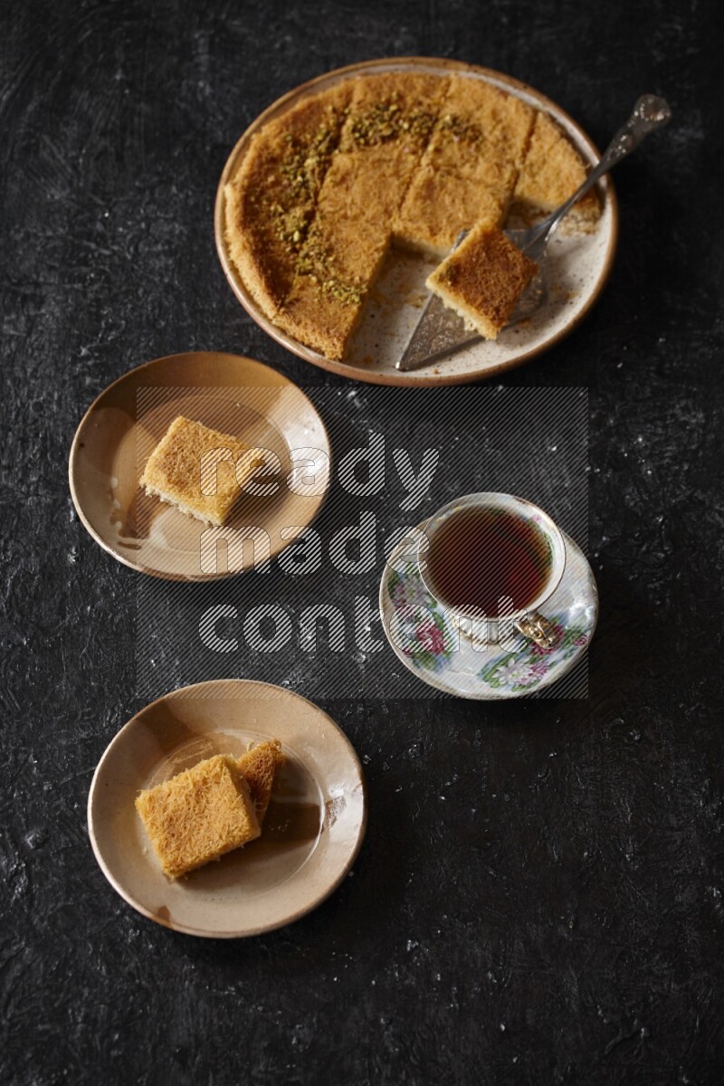 konafa with tea in a dark setup