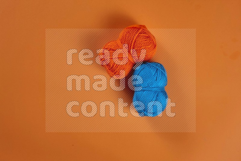 Blue sewing supplies on orange background