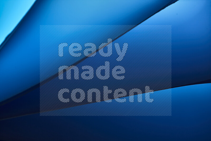 An abstract art piece displaying smooth curves in cold gradients created by colored light