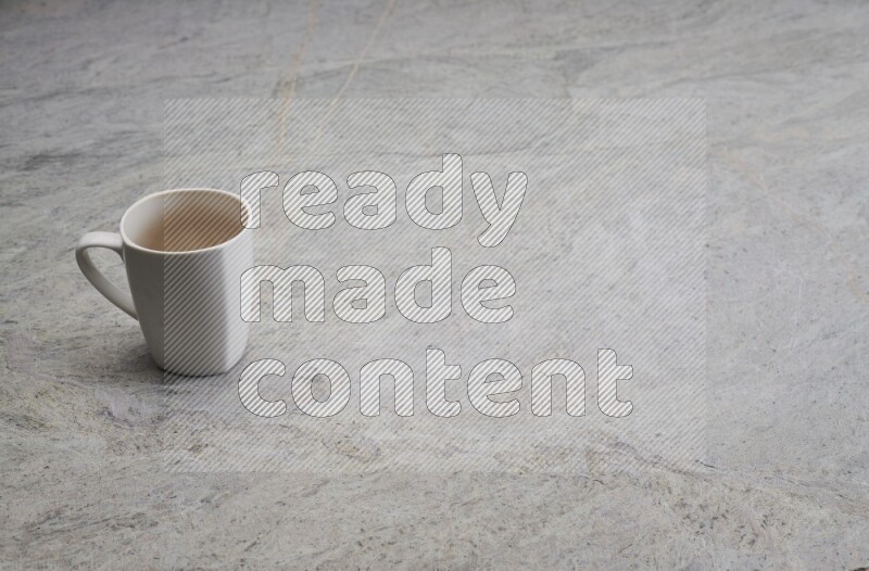 A white ceramic mug on grey marble background