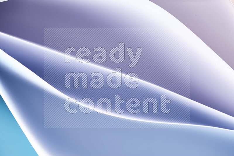 This image showcases an abstract paper art composition with paper curves in blue and white gradients created by colored light