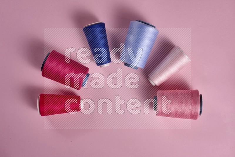 Blue sewing supplies on pink background