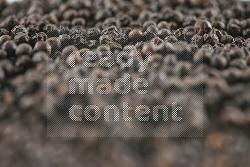 Black pepper beads on white background