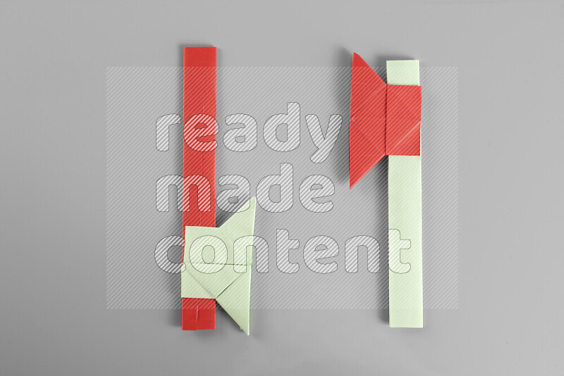 Origami axe on grey background