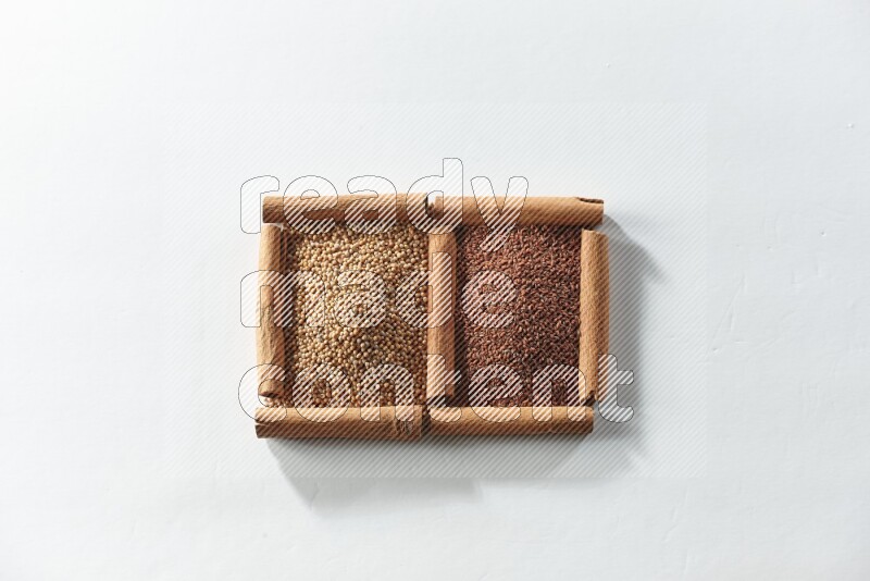 2 squares of cinnamon sticks full of mustard seeds and garden cress on white flooring