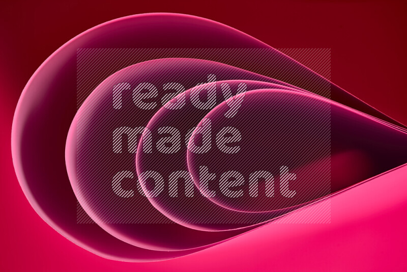 An abstract art of paper folded into smooth curves in pink gradients