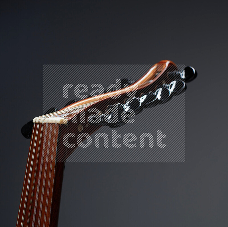 parts of a brown wooden Oud in a gray background