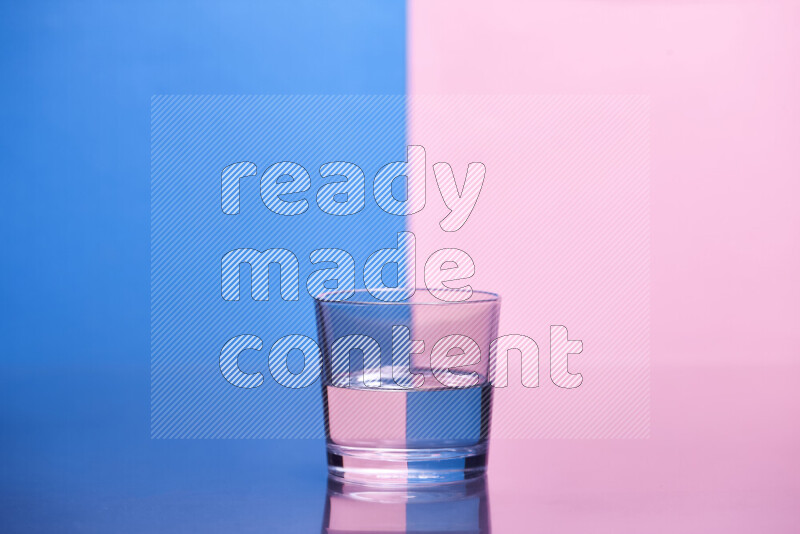 The image features a clear glassware filled with water, set against blue and rose background