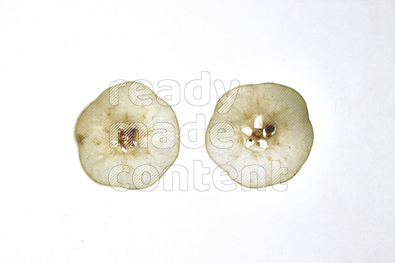 Pear slices on illuminated white background