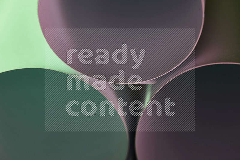 The image shows an abstract paper art with circular shapes in varying shades of green and pink