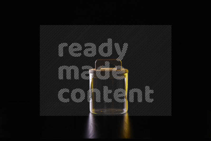 Glassware with rim light in yellow and white against black background