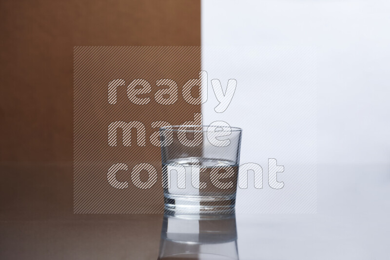 The image features a clear glassware filled with water, set against white and brown background