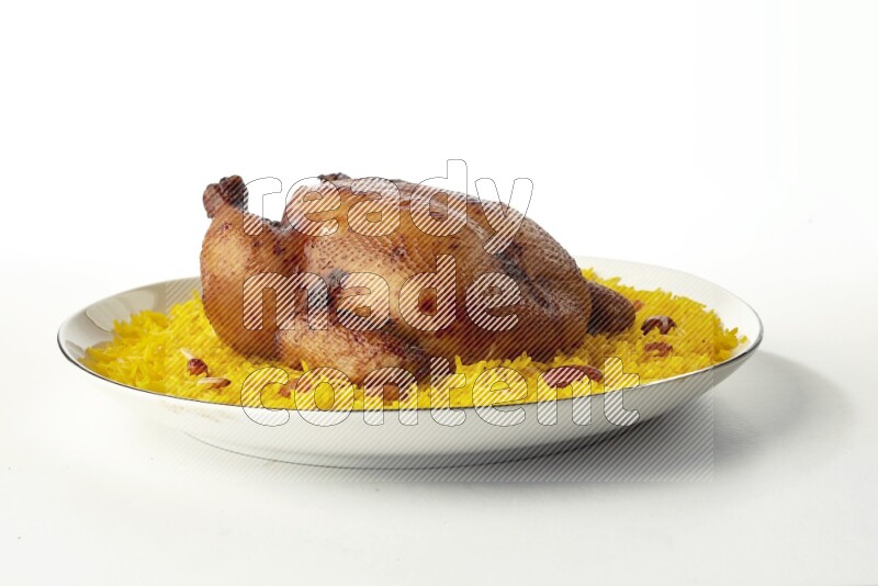 yellow  basmati Rice with kabsa chicken pieces on a white plate with a silver rim direct on white background