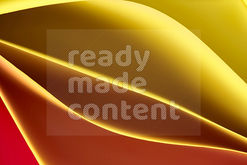 This image showcases an abstract paper art composition with paper curves in yellow, red and brown gradients created by colored light