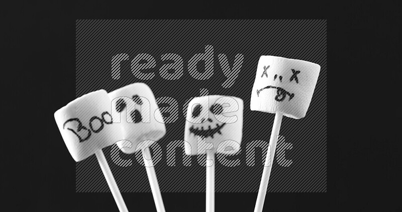 Halloween shapes on marshmallows on black background