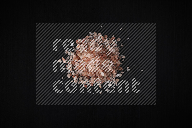 A bunch of coarse himalayan salt crystals on black background