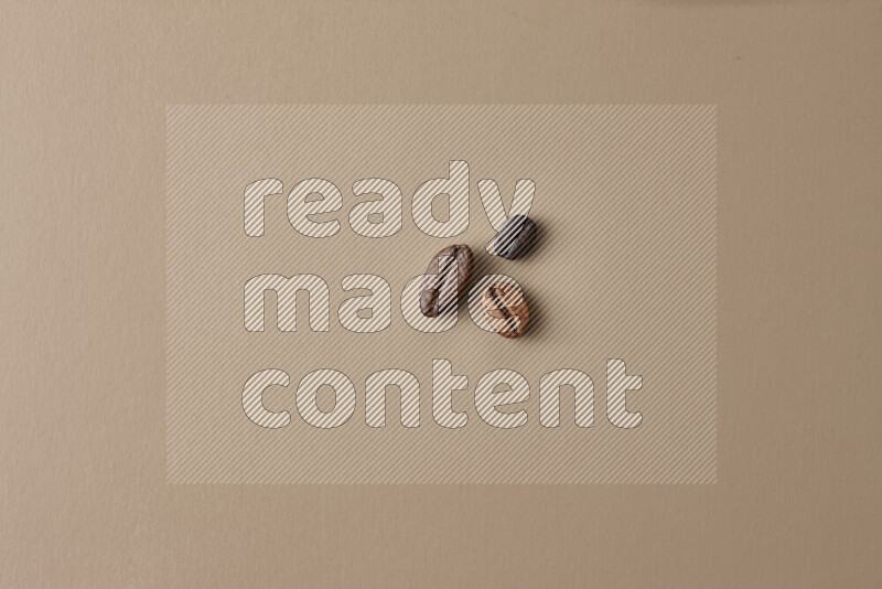 Roasted coffee beans on beige background