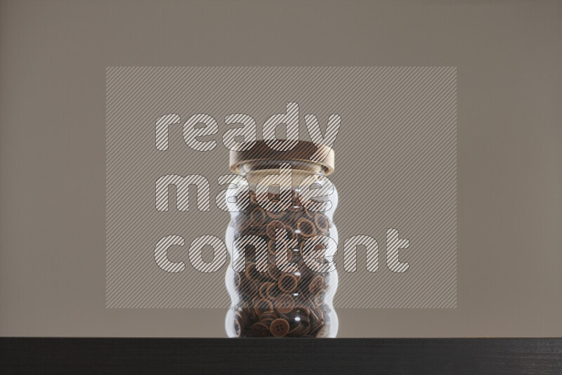 Buttons in a glass jar on black background