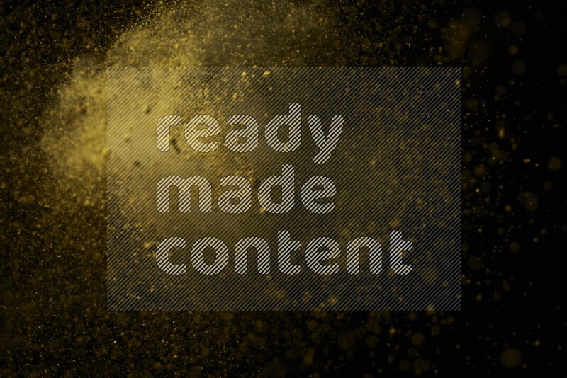 Yellow powder explosion on black background
