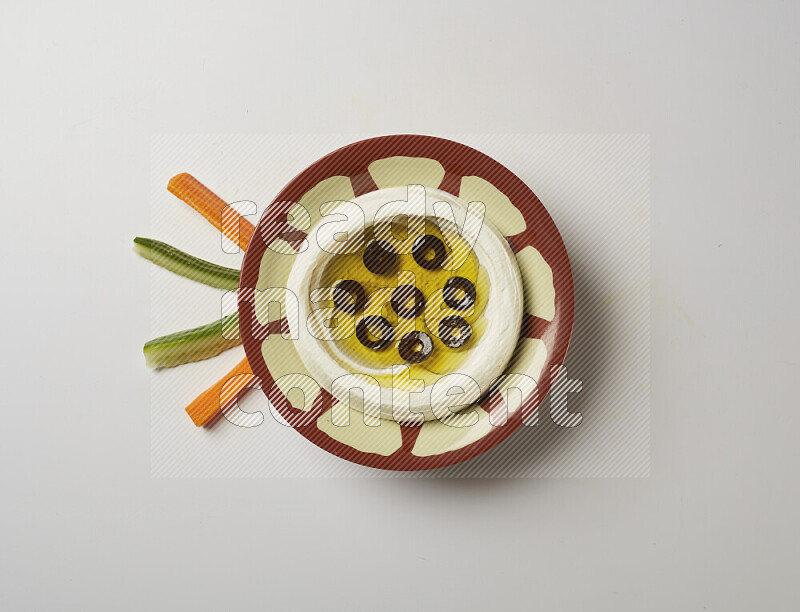 Lebnah garnished with sliced olives in a traditional plate on a white background