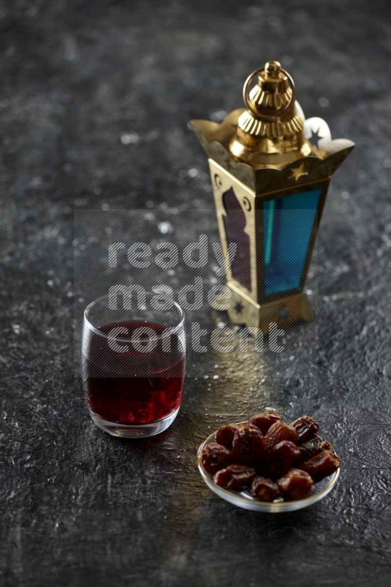 Quran with a prayer beads on textured black background