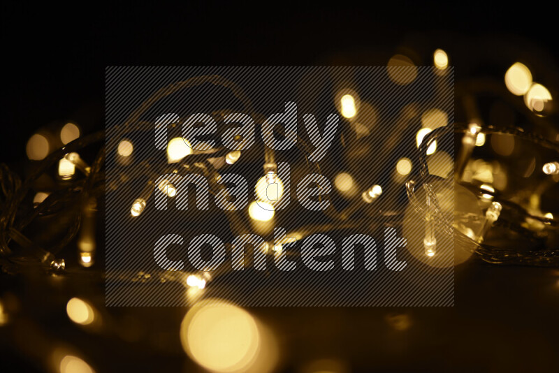 Light bulbs glowing against backdrop of golden bokeh