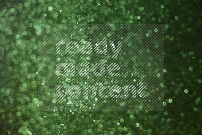 Green glitter powder isolated on black background