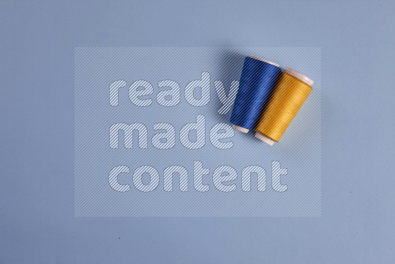 Yellow sewing supplies on blue background