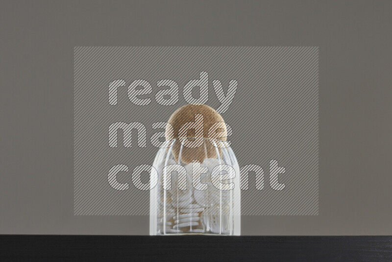 Buttons in a glass jar on black background
