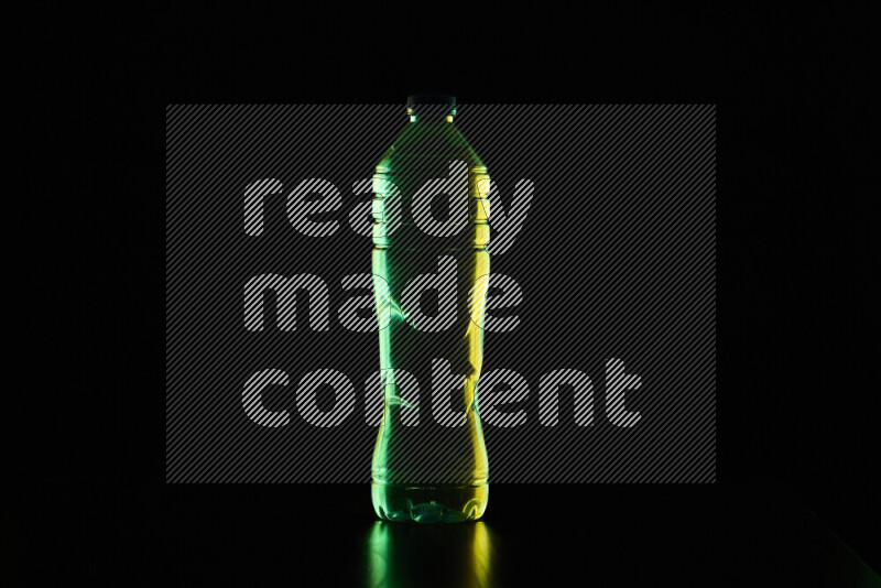 Water bottle with colored rim light against black background