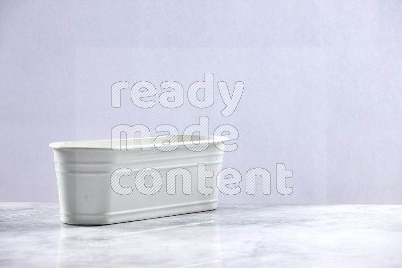 An Empty White Plant Pot on light grey Marble Flooring 15 degree angle