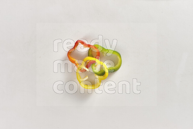 Assorted bell pepper slices on white background