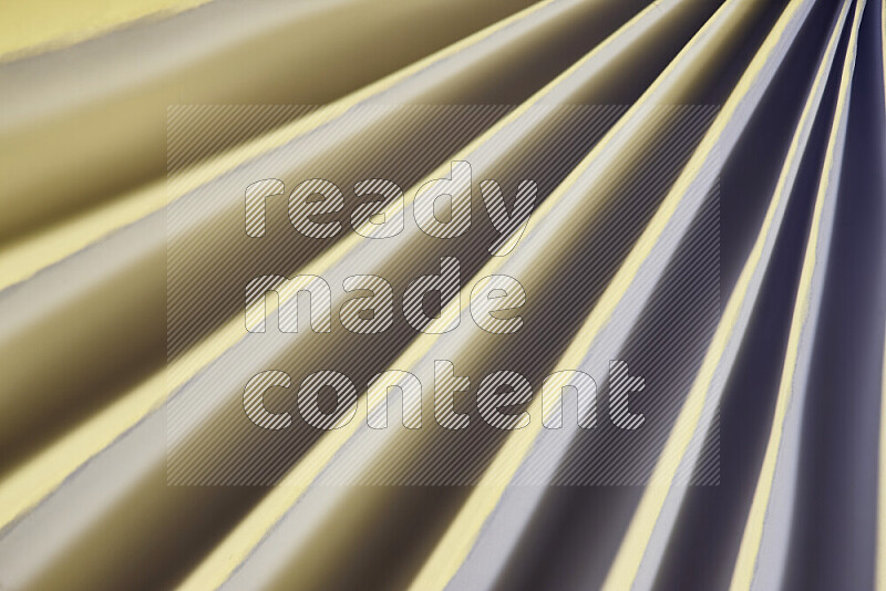 An image presenting an abstract paper pattern of lines in white and gold tones