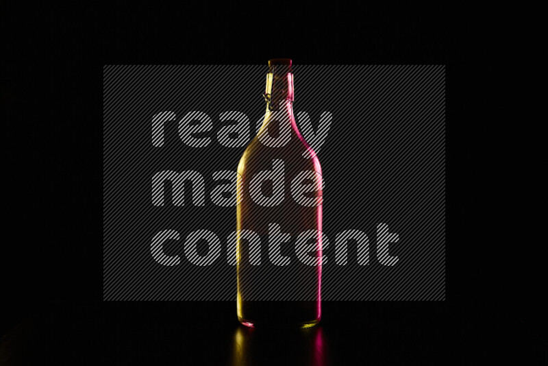 Water bottle with colored rim light against black background