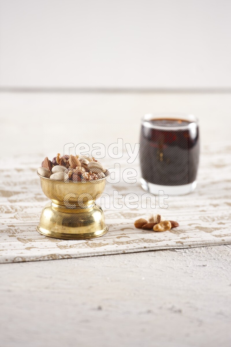 Nuts in a metal bowl with tamarind in a light setup
