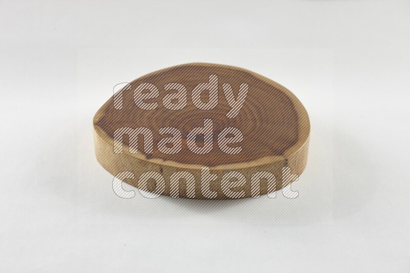 A circular wooden slab with natural textures on white background