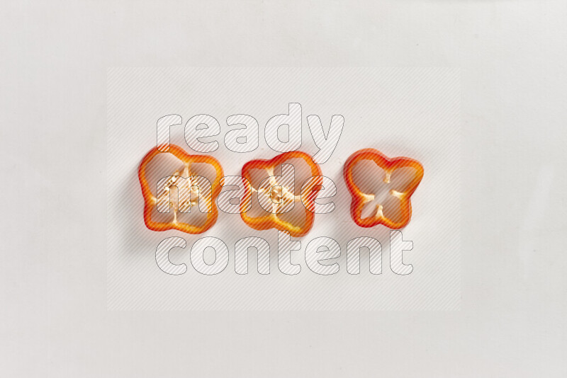 Red bell pepper slices on white background