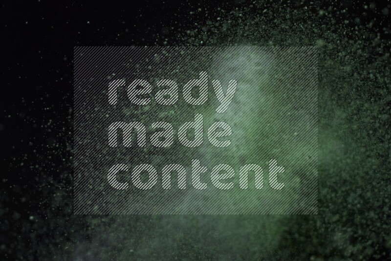 Green powder explosion on black background
