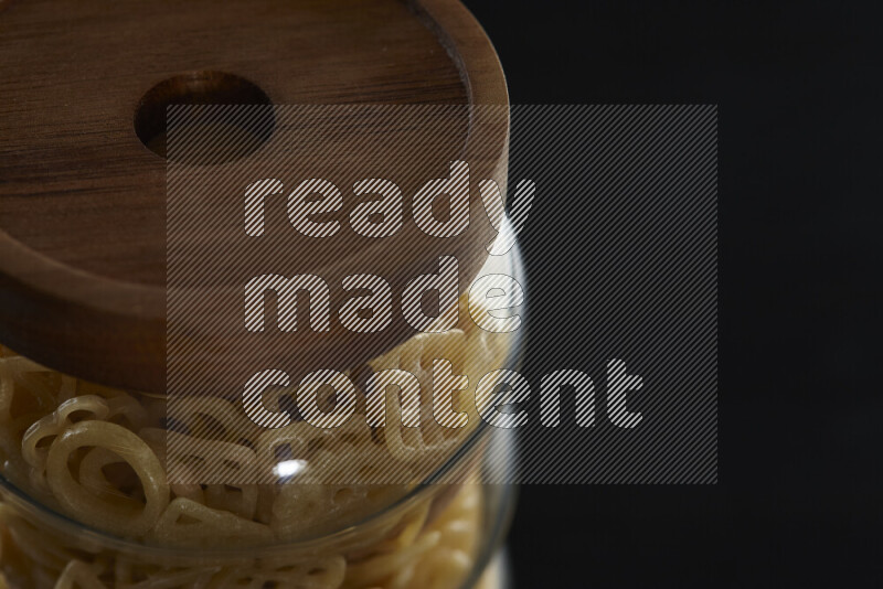 Snacks in a glass jar on black background