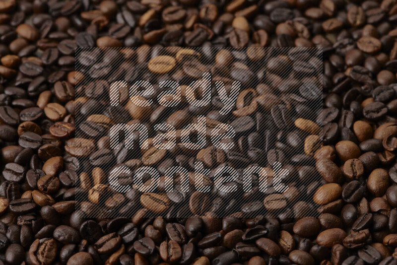 Roasted coffee beans on beige background