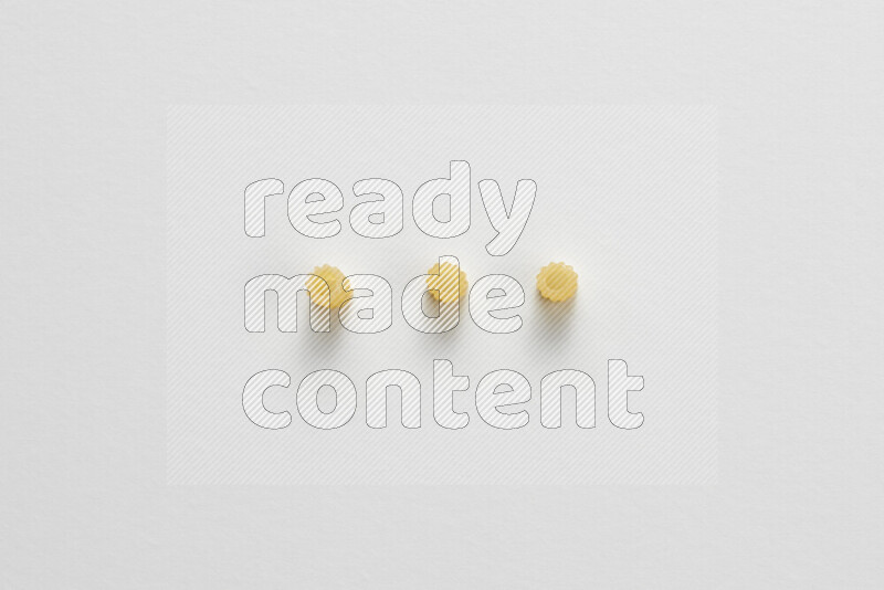 Small rings pasta on white background
