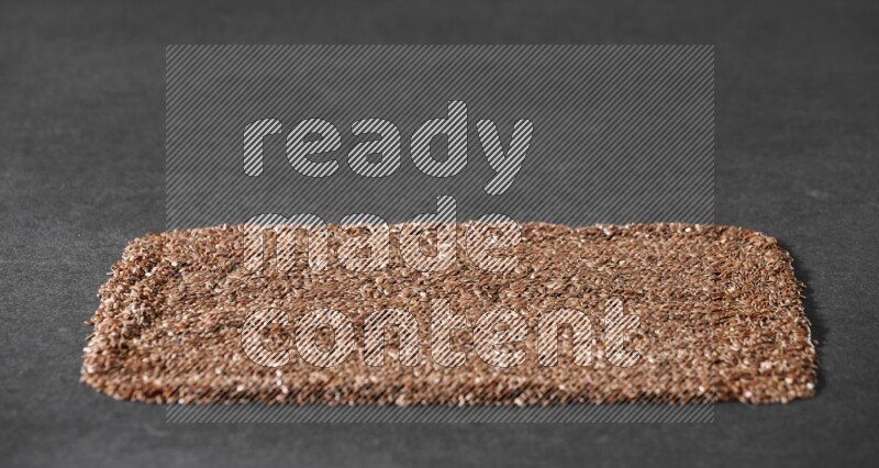 حبوب بذر الكتان تملأ الخلفية على أرضية سوداء