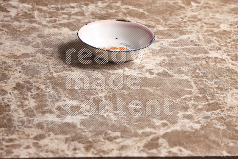 A vintage metal plate on beige marble background