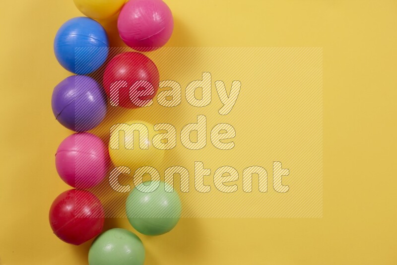 Multicolored plastic balls on different colored backgrounds (kids toys)