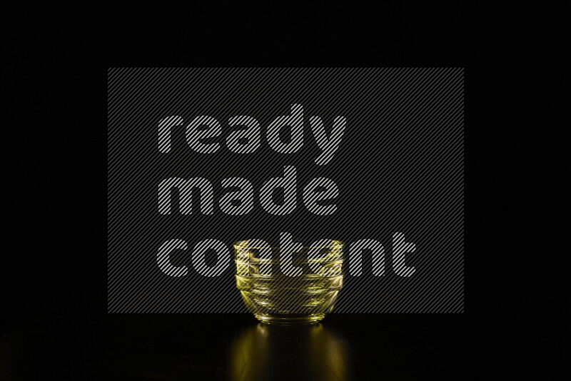 Glassware with rim light in yellow against black background