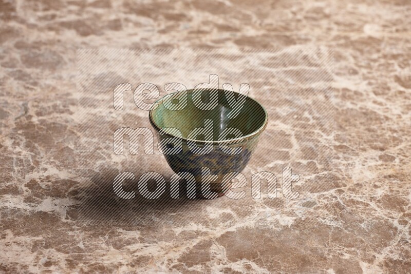 A decorative pottery bowl on beige marble background