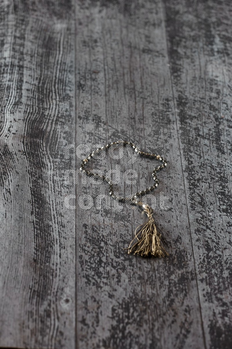 A prayer beads placed on wooden background